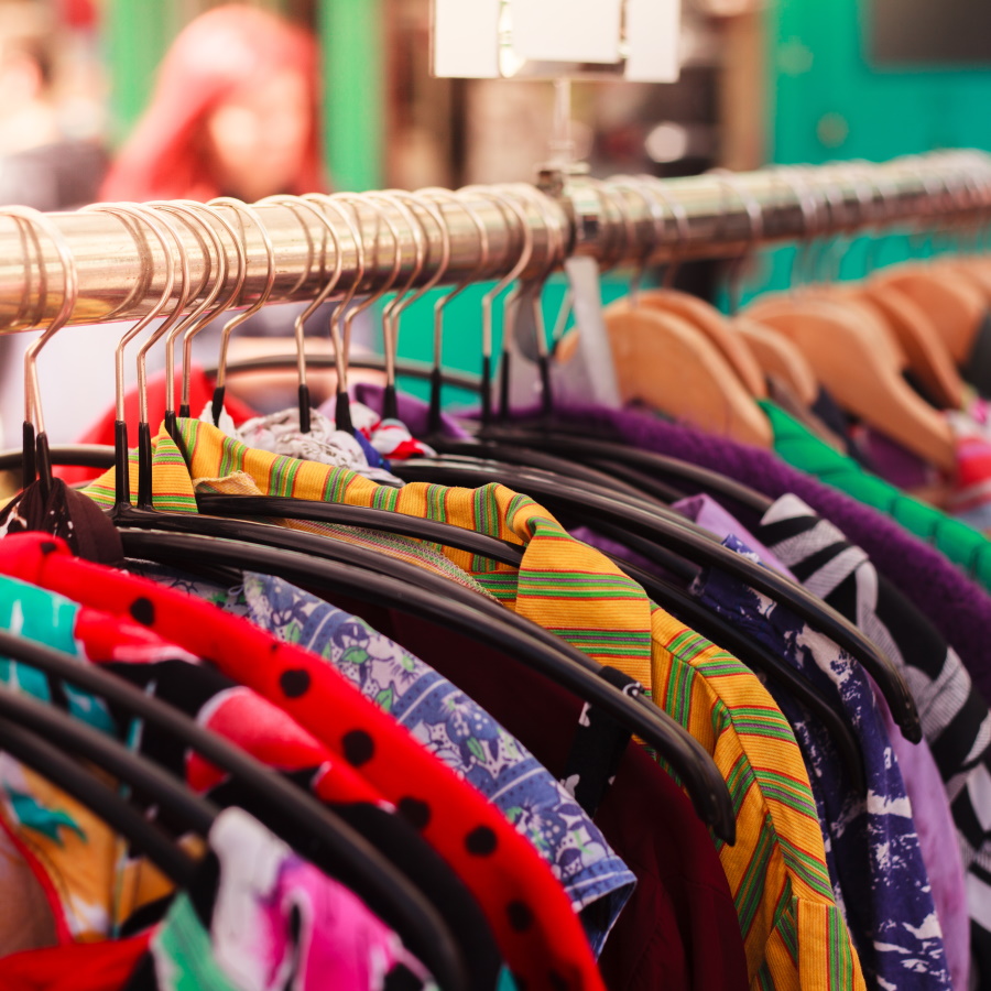 Clotes Hanging On A Rail At A Street Market Outdoors